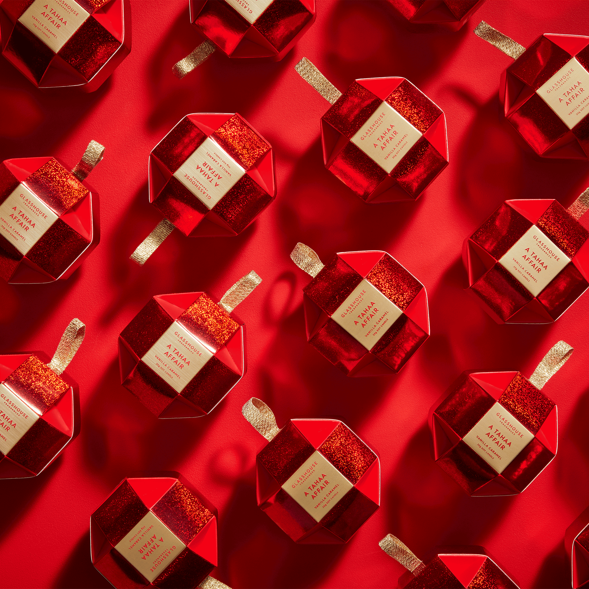Glasshouse Fragrances A Tahaa Affair Vanilla Caramel 1.1oz Soy Candles in Christmas Baubles - animated on red background